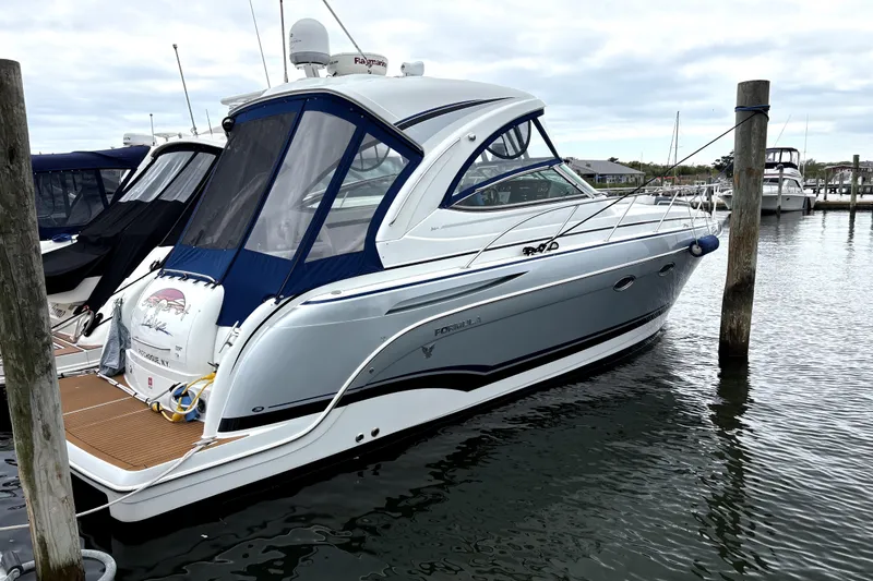 The Image of 2013 Formula 34 Performance Cruiser docked in a marina, showcasing sleek design and modern features. - 0