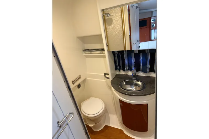 Slide: The Image of 2013 Formula 34 Performance Cruiser bathroom with sink, mirror, and toilet. - 11