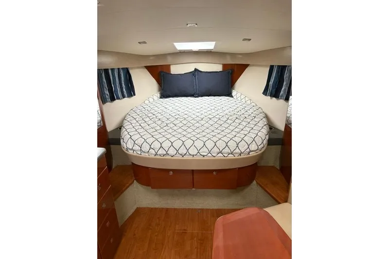Slide: The Image of 2013 Formula 34 Performance Cruiser cabin with cozy bed and elegant wood finish. - 2