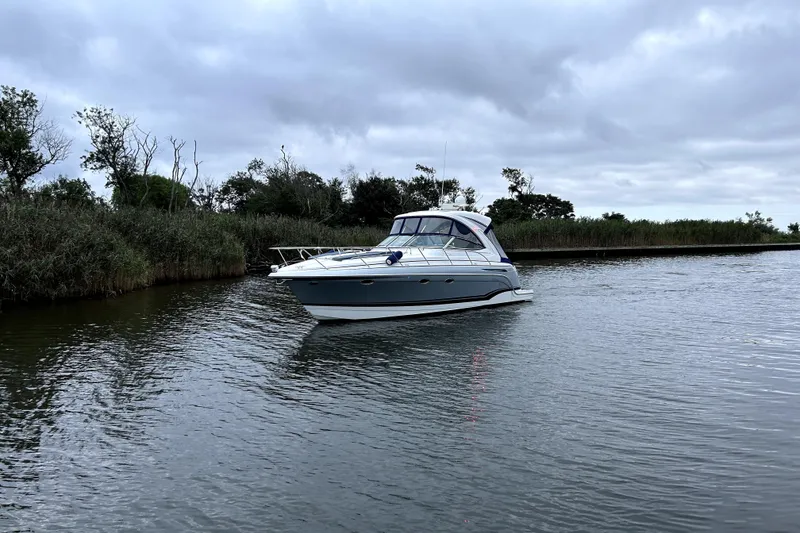 Slide: The Image of 2013 Formula 34 Performance Cruiser on a calm river under cloudy skies. - 5