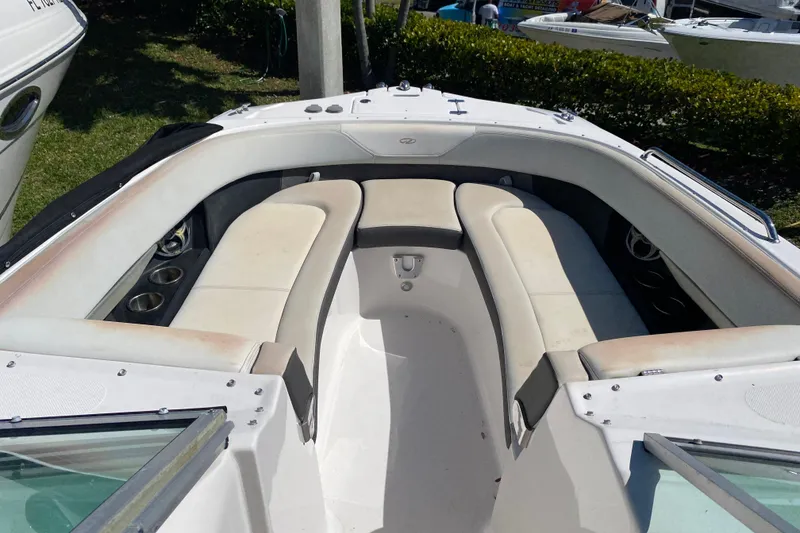 Slide: The Image of 2013 Regal 27 FasDeck RX boat interior with white seating and cup holders. - 10