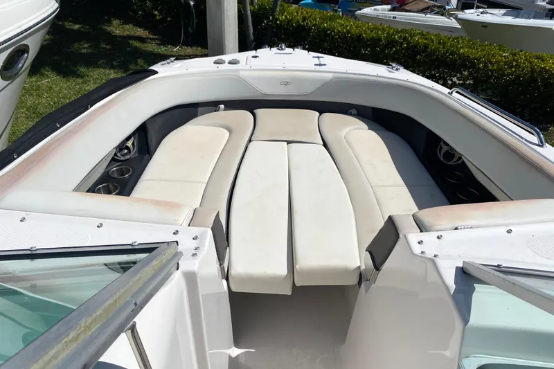Slide: The Image of 2013 Regal 27 FasDeck RX boat interior with white cushioned seating. - 12