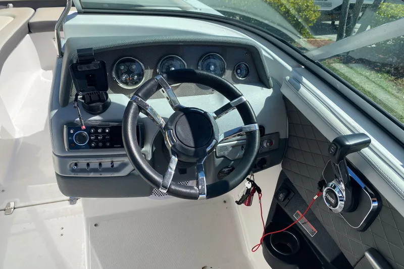 Slide: The Image of Steering console of a 2013 Regal 27 FasDeck RX boat with modern controls and gauges. - 14