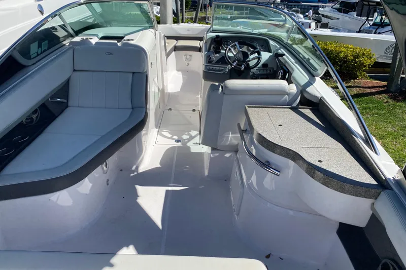 Slide: The Image of Interior view of a 2013 Regal 27 FasDeck RX boat, featuring seating and helm. - 17