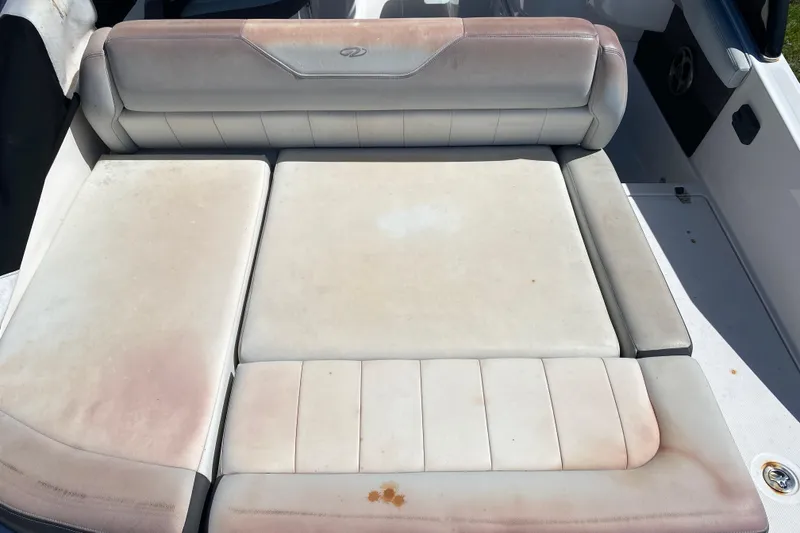 Slide: The Image of 2013 Regal 27 FasDeck RX boat seating with visible wear and discoloration. - 18