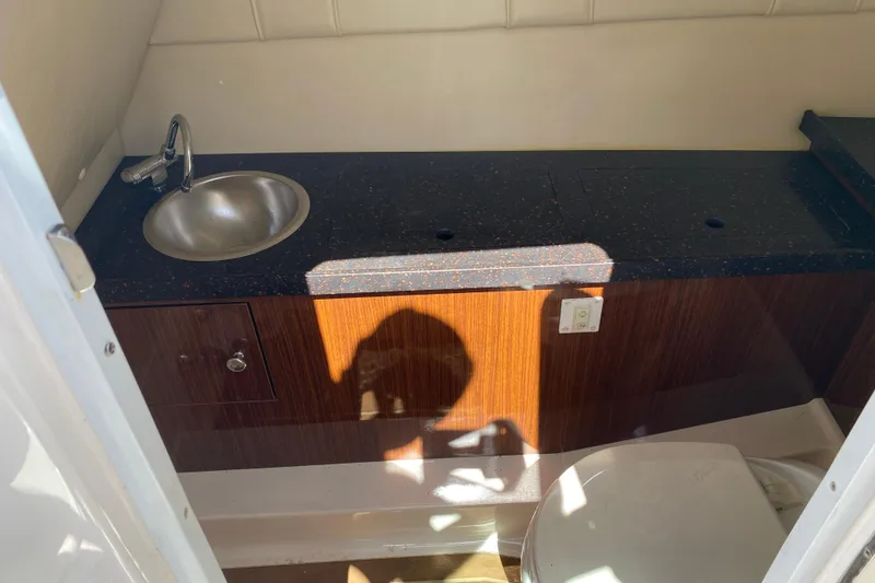 Slide: The Image of 2013 Regal 27 FasDeck RX boat bathroom with sink and toilet. - 19