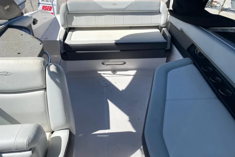Slide: The Image of 2013 Regal 27 FasDeck RX boat interior with white seating and cup holders. - 21