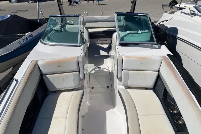 Slide: The Image of 2013 Regal 27 FasDeck RX boat interior with white seating and dual windshields. - 23