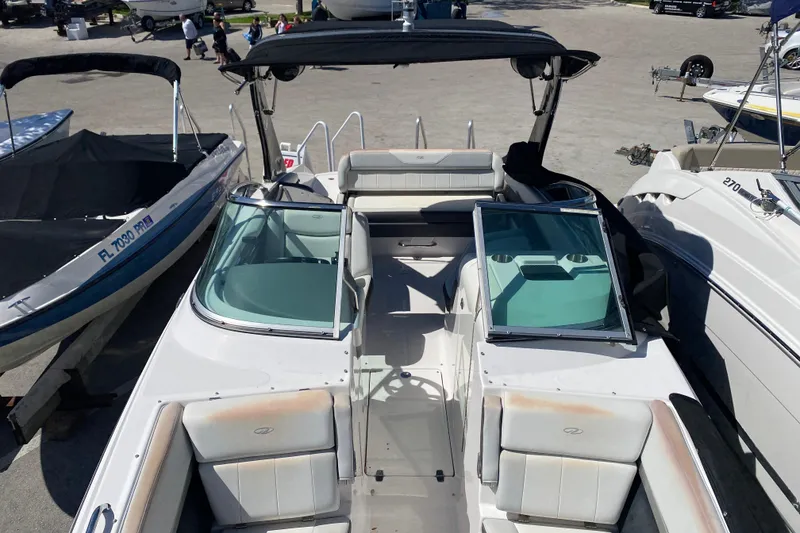 Slide: The Image of 2013 Regal 27 FasDeck RX boat with open seating and sleek design. - 24