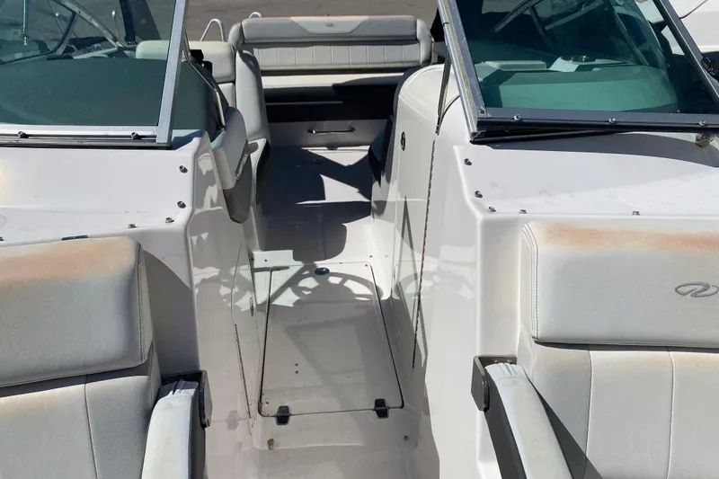 Slide: The Image of 2013 Regal 27 FasDeck RX boat interior with seating and windshield. - 25