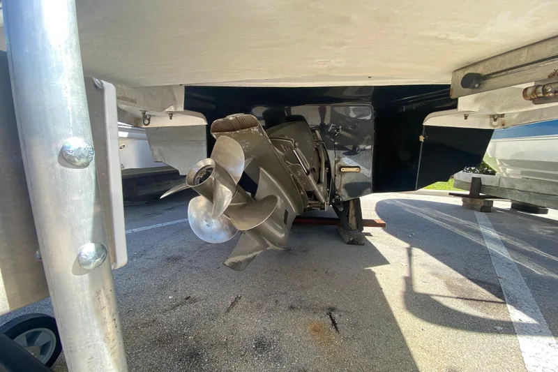 Slide: The Image of 2013 Regal 27 FasDeck RX boat propeller and stern view in a parking area. - 5