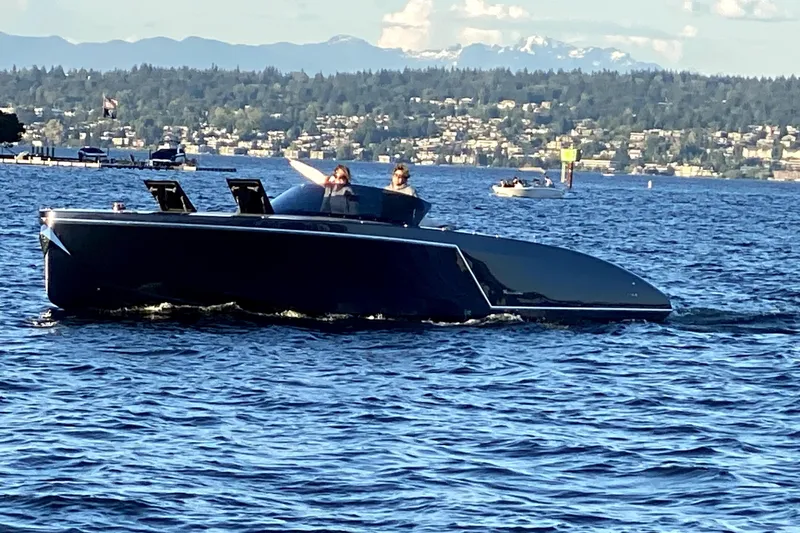 Slide: The Image of 2020 Frauscher 1017 GT luxury boat cruising on a scenic lake. - 2