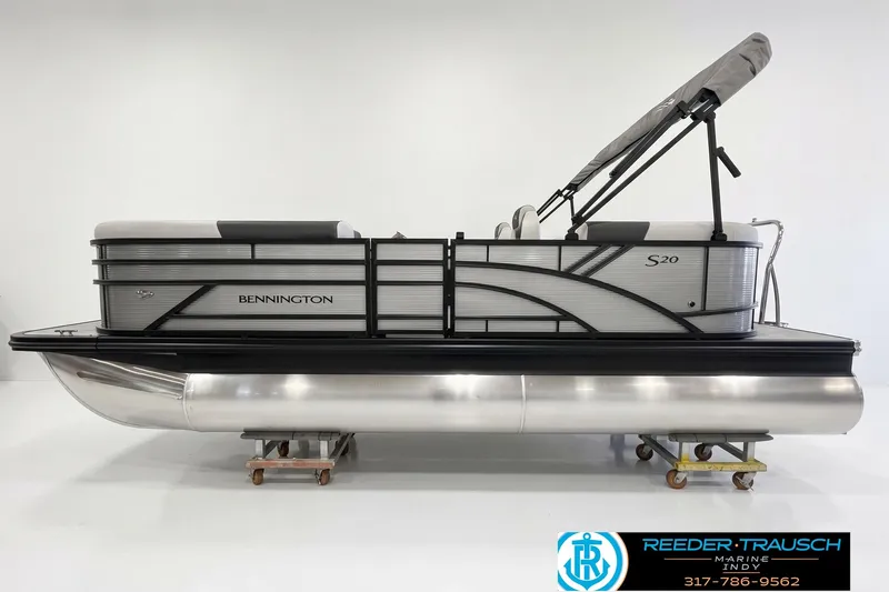 The Image of 2026 Bennington 20 SSR pontoon boat with sleek design and canopy, displayed in showroom. - 1