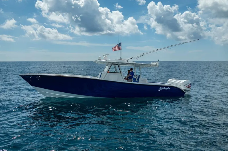 Slide: The Image of 2023 Yellowfin 39 Offshore boat on open sea under cloudy sky. - 13