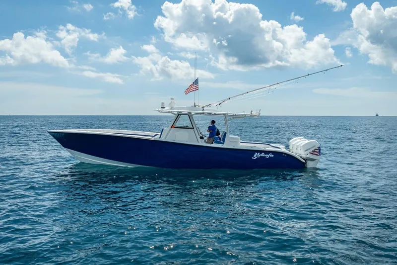 Slide: The Image of 2023 Yellowfin 39 Offshore boat on open sea under blue sky. - 14