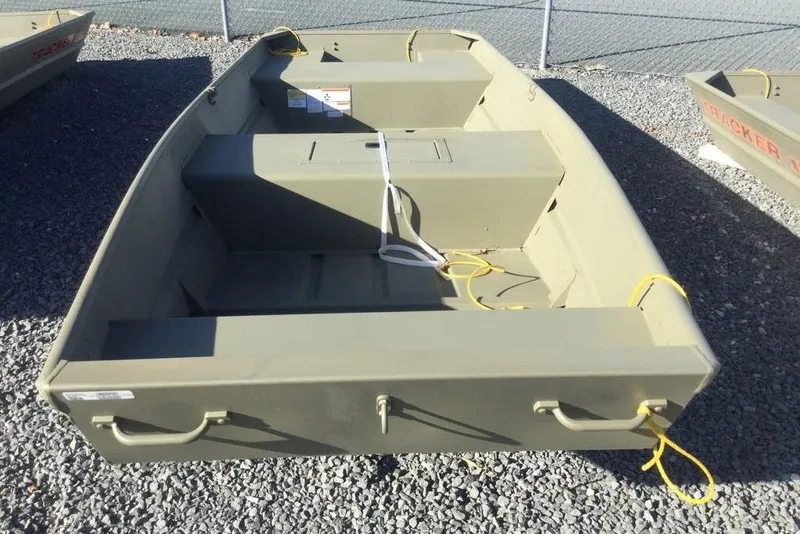 Slide: The Image of 2026 Tracker Grizzly 15 Jon boat on gravel, featuring durable design and utility. - 2