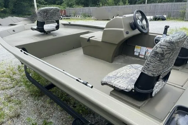 Slide: The Image of 2026 Tracker Grizzly 1754 SC boat with camouflage seats and steering console. - 4