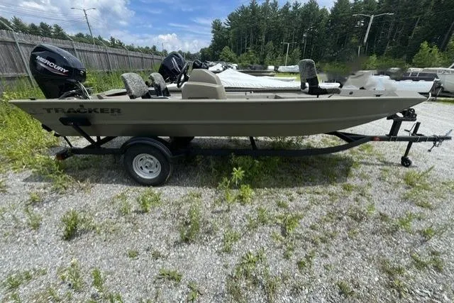 Slide: The Image of 2026 Tracker Grizzly 1754 SC boat on trailer, parked outdoors on gravel. - 2