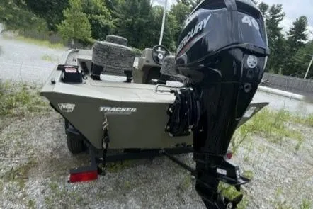 Slide: The Image of 2026 Tracker Grizzly 1754 SC boat with Mercury outboard motor on gravel. - 7
