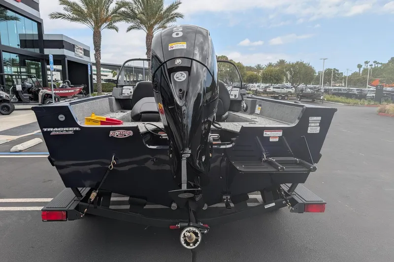 Slide: The Image of 2026 Tracker Pro Guide V-175 WT boat with outboard motor, parked outdoors. - 4