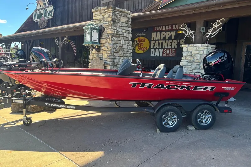 The Image of Red 2026 Tracker Pro Team 195 boat on trailer outside Bass Pro Shops. - 0