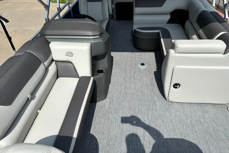 Slide: The Image of 2026 Sun Tracker Fishin' Barge 20 DLX interior with gray seating and carpeted floor. - 4