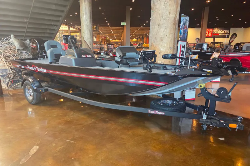 The Image of 2026 Tracker Bass Tracker Classic XL boat displayed indoors on a trailer. - 0