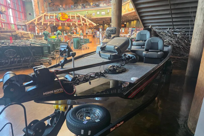 Slide: The Image of 2026 Tracker Bass Tracker Classic XL boat displayed indoors at Bass Pro Shops. - 5
