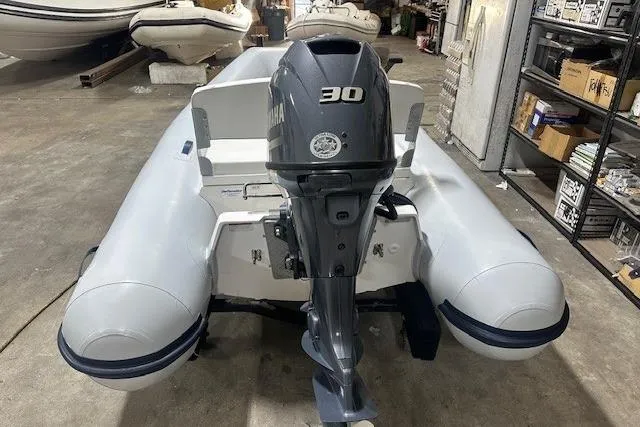 Slide: The Image of 2022 AB Inflatables Mares 11 VSX with Yamaha 30 outboard motor in a storage facility. - 3