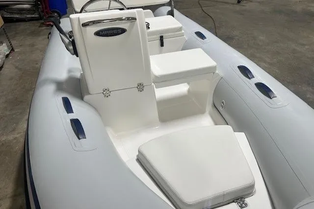 Slide: The Image of 2022 AB Inflatables Mares 11 VSX boat interior with white seating and steering console. - 4