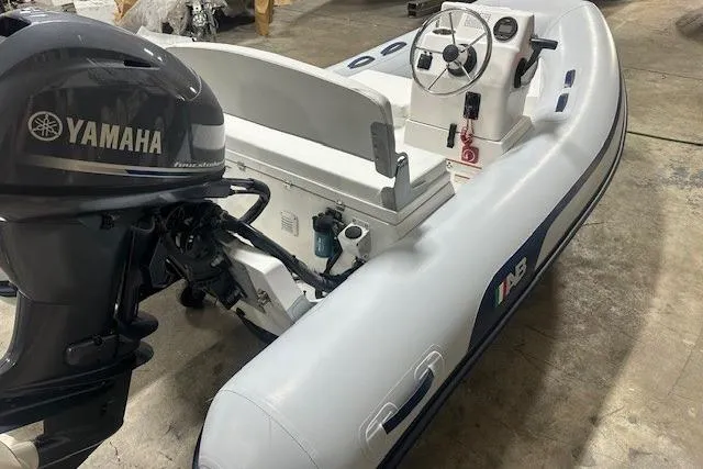 Slide: The Image of 2022 AB Inflatables Mares 11 VSX boat with Yamaha outboard motor in a garage setting. - 6