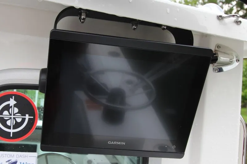 Slide: The Image of Garmin display on 2023 Parker 2320 Sport Cabin boat, mounted near steering wheel. - 16