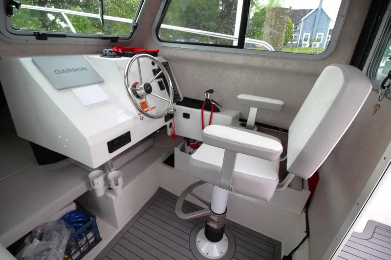 Slide: The Image of 2023 Parker 2320 Sport Cabin interior with steering wheel and Garmin navigation system. - 18