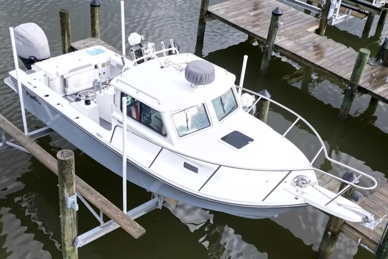 Slide: The Image of 2023 Parker 2320 Sport Cabin boat docked at marina, aerial view. - 6