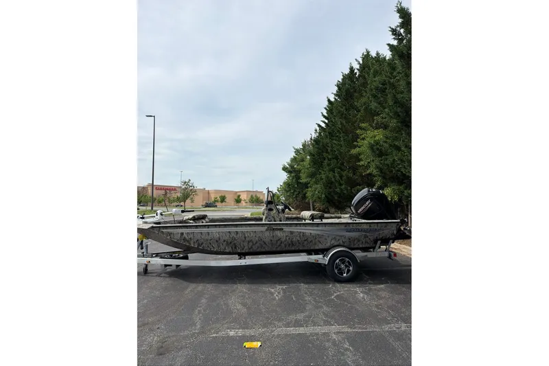 The Image of 2026 Ranger RB190 boat on trailer in parking lot, surrounded by trees. - 0