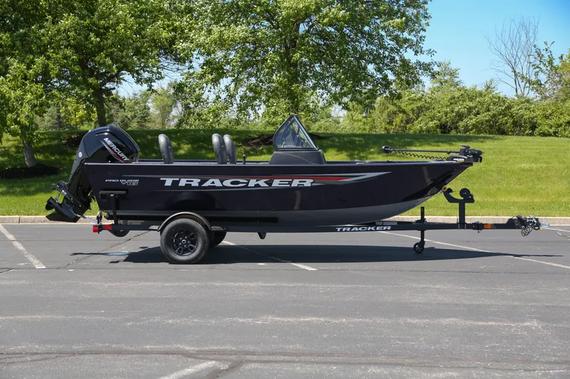 The Image of 2026 Tracker Pro Guide V-16 WT boat on trailer in parking lot. - 0