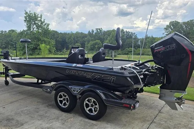 Slide: The Image of 2026 Nitro Z21 XL boat with dual seats and powerful engine, parked on a trailer. - 1