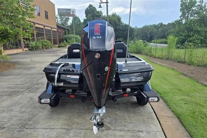 Slide: The Image of 2026 Nitro Z21 XL boat with powerful V8 engine, parked outdoors on a sunny day. - 2