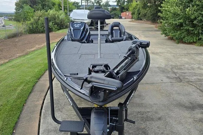 Slide: The Image of 2026 Nitro Z21 XL fishing boat on trailer, parked on concrete driveway. - 6