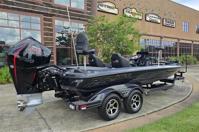 Slide: The Image of 2026 Nitro Z21 XL boat with powerful engine, parked outside showroom. - 3