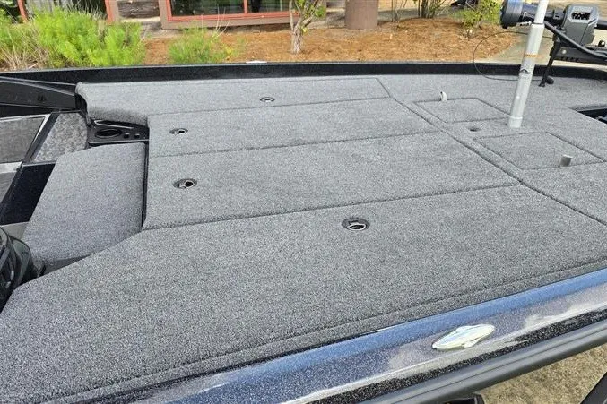 Slide: The Image of 2026 Nitro Z21 XL boat deck with gray carpet and storage compartments. - 11