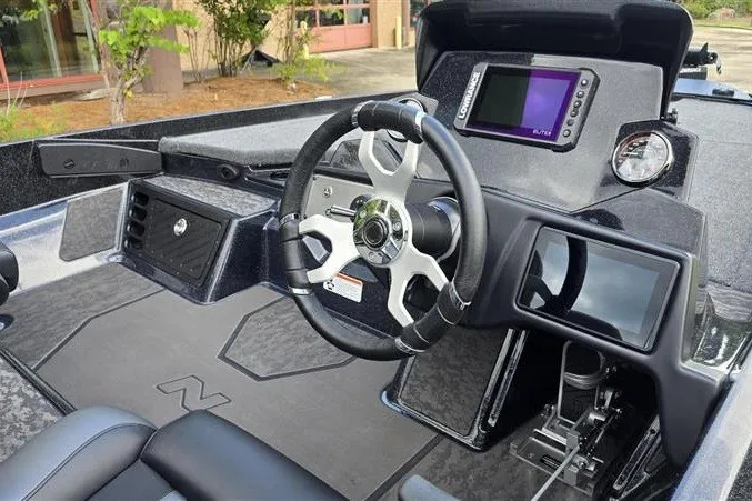 Slide: The Image of 2026 Nitro Z21 XL boat cockpit with steering wheel, digital displays, and control panel. - 8