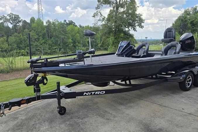 Slide: The Image of 2026 Nitro Z21 XL boat on trailer, parked outdoors with lush greenery background. - 7