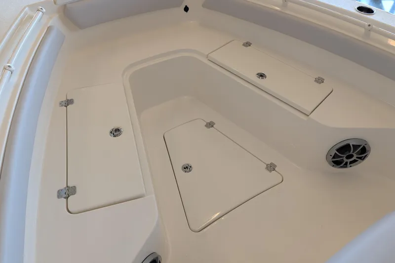 Slide: The Image of 2026 Mako 226 Center Console boat interior with storage compartments and speaker. - 10