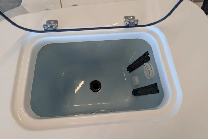 Slide: The Image of Livewell compartment of 2026 Mako 226 Center Console boat, open lid view. - 14