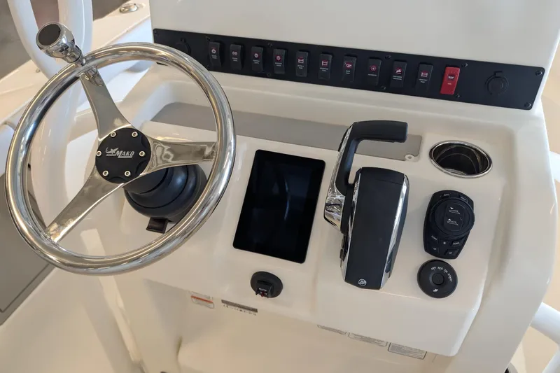 Slide: The Image of Steering console of 2026 Mako 226 Center Console boat with controls and switches. - 12