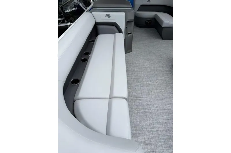 Slide: The Image of 2026 Sun Tracker Party Barge 18 DLX interior with plush seating and cup holders. - 9