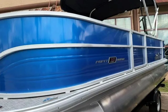 Slide: The Image of 2026 Sun Tracker Party Barge 18 DLX pontoon boat with blue exterior and sleek design. - 3