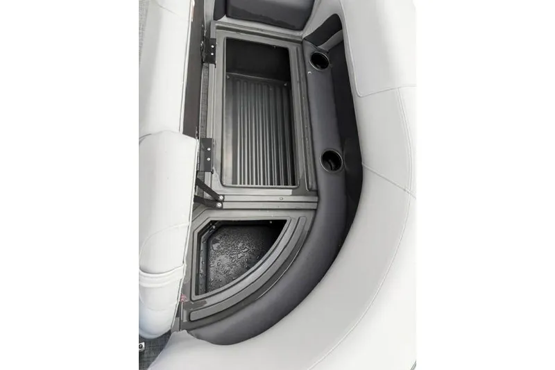 Slide: The Image of 2026 Sun Tracker Party Barge 18 DLX storage compartment with cup holders and seating. - 15