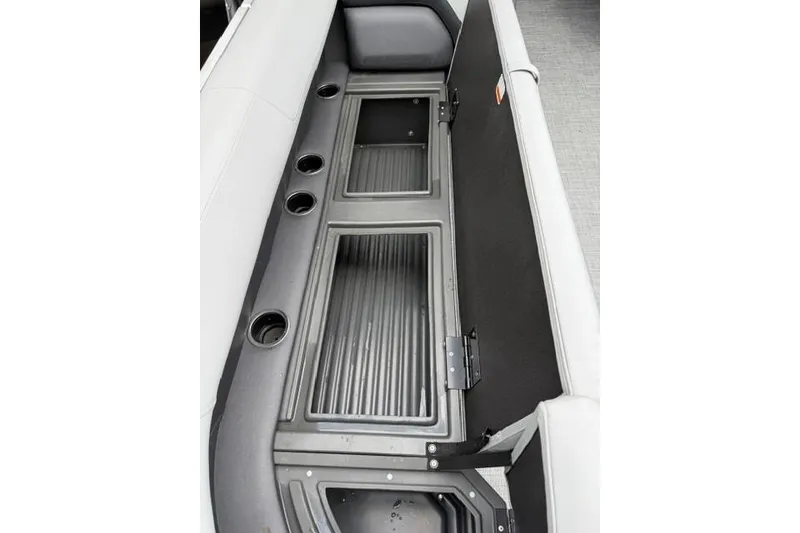 Slide: The Image of 2026 Sun Tracker Party Barge 18 DLX storage compartments with cup holders and seating. - 10